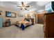 Bedroom with a colorful quilt, ceiling fan, and a vintage style dresser at 4710 Se 30Th Ct, Ocala, FL 34480