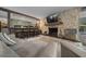 This living room features a stone fireplace and bar with a clear view into the kitchen at 4710 Se 30Th Ct, Ocala, FL 34480