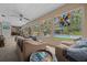 Spacious living room with large windows offering views of the pool and lush backyard at 4710 Se 30Th Ct, Ocala, FL 34480