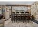 Cozy seating with stone accent wall, bar, and a view of the kitchen in the living space at 4710 Se 30Th Ct, Ocala, FL 34480