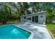 Poolside pool house with outdoor shower and landscaping at 4710 Se 30Th Ct, Ocala, FL 34480