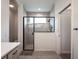 Modern bathroom featuring a glass-enclosed shower with gray tiling and sleek black fixtures at 4743 Nw 11Th Ct, Ocala, FL 34475
