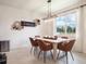 Bright dining room with modern light fixture, seating for six, and large window at 4743 Nw 11Th Ct, Ocala, FL 34475
