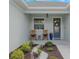 Cozy front porch with rocking chairs, decorative plants, and a stylish front door at 4743 Nw 11Th Ct, Ocala, FL 34475