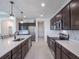 Modern kitchen features stainless steel appliances, white counters and dark cabinetry at 4743 Nw 11Th Ct, Ocala, FL 34475