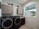 Well-organized laundry room featuring modern appliances and ample cabinet space at 4743 Nw 11Th Ct, Ocala, FL 34475