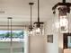 Modern pendant lights over the kitchen island, view of the dining and living area at 4743 Nw 11Th Ct, Ocala, FL 34475