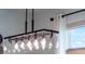 Modern light fixture design with clear glass and Edison style bulbs over dining area at 4743 Nw 11Th Ct, Ocala, FL 34475