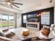 Modern living room with a stylish fireplace, large TV, and comfortable leather sofa at 4743 Nw 11Th Ct, Ocala, FL 34475