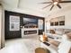 Well-lit living room with a fireplace, large windows, and a comfortable sectional sofa at 4743 Nw 11Th Ct, Ocala, FL 34475
