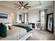 Large main bedroom boasts a ceiling fan, fireplace, and decorative wall art at 4743 Nw 11Th Ct, Ocala, FL 34475