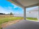 Covered patio overlooking a large backyard with both iron and vinyl fencing at 4743 Nw 11Th Ct, Ocala, FL 34475