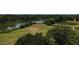 Aerial view of the landscape showcasing lush greenery, a serene lake, and beautiful skies at 606 Midway Dr # B, Ocala, FL 34472