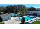 Aerial view of the community pool with a clubhouse, lounge chairs and umbrellas for residents' enjoyment at 606 Midway Dr # B, Ocala, FL 34472