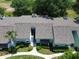 Aerial view of condo featuring a well-maintained roof, landscaping, and nearby foliage at 606 Midway Dr # B, Ocala, FL 34472