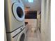 Bathroom with laundry area featuring stackable washer and dryer, vanity, and toilet at 606 Midway Dr # B, Ocala, FL 34472