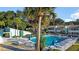 Community pool area with palm trees, tables, and lounge chairs for residents' enjoyment at 606 Midway Dr # B, Ocala, FL 34472