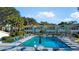 Inviting community pool area with ample seating and views of the surrounding buildings and palm trees at 606 Midway Dr # B, Ocala, FL 34472