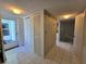 Hallway featuring tile flooring, white closet with louvered doors, and neutral wallpaper at 606 Midway Dr # B, Ocala, FL 34472