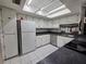 Bright kitchen featuring white cabinets and appliances, complemented by a skylight at 606 Midway Dr # B, Ocala, FL 34472