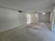 Spacious living room featuring carpet and a view into an adjacent room at 606 Midway Dr # B, Ocala, FL 34472