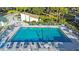 Aerial view of a sparkling community pool with lounge chairs and umbrellas for relaxation and leisure at 606 Midway Dr # B, Ocala, FL 34472