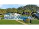 Community pool surrounded by lush landscaping, lounge chairs, and a clubhouse for residents' enjoyment at 606 Midway Dr # B, Ocala, FL 34472