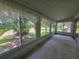 Enclosed sunroom with large windows providing views of the landscaped backyard at 606 Midway Dr # B, Ocala, FL 34472