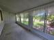 Enclosed sunroom with large windows providing views of the lush, green outdoors at 606 Midway Dr # B, Ocala, FL 34472