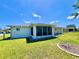 View of the screened in lanai from the backyard lawn at 6070 Sw 98Th Loop, Ocala, FL 34476