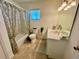 Well-lit bathroom with a shower-tub combo and a single sink vanity at 6070 Sw 98Th Loop, Ocala, FL 34476