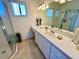 Well-lit bathroom with a glass shower and long vanity at 6070 Sw 98Th Loop, Ocala, FL 34476