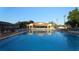 Large community pool surrounded by lounge chairs and lush greenery, ideal for relaxation at 6070 Sw 98Th Loop, Ocala, FL 34476
