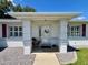 Close up shot of the front porch featuring white pillars and a decorative wreath at 6070 Sw 98Th Loop, Ocala, FL 34476