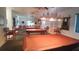 Well-lit game room with pool tables, seating, and large windows offering natural light at 6070 Sw 98Th Loop, Ocala, FL 34476