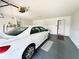 Spacious two car garage with an automatic door, overhead storage, and a side door at 6070 Sw 98Th Loop, Ocala, FL 34476