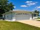 Side view of a two car garage with white trim at 6070 Sw 98Th Loop, Ocala, FL 34476