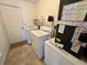 A functional laundry room with modern appliances and ample storage space at 6070 Sw 98Th Loop, Ocala, FL 34476