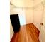 Compact walk-in closet featuring wire shelving and laminate flooring for practical storage at 6070 Sw 98Th Loop, Ocala, FL 34476