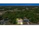 Aerial view of a home with a pool surrounded by lush greenery and nearby highway access at 6306 Pecan Crse, Ocala, FL 34472