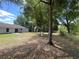 Expansive backyard with mature trees and a patio, perfect for outdoor activities at 6306 Pecan Crse, Ocala, FL 34472