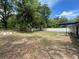Spacious backyard featuring a patio area with outdoor seating and a white fence at 6306 Pecan Crse, Ocala, FL 34472