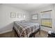 Simple bedroom with a plaid bedspread and plenty of natural light at 6306 Pecan Crse, Ocala, FL 34472