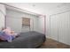 Comfortable bedroom with a pink four-poster bed and double door closet at 6306 Pecan Crse, Ocala, FL 34472