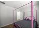 Cozy bedroom featuring a pink four-poster bed and plush unicorn doll at 6306 Pecan Crse, Ocala, FL 34472