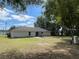 View of the back of the house and expansive backyard with seating area at 6306 Pecan Crse, Ocala, FL 34472