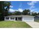 Charming single-story home with a well-manicured lawn and attached two car garage at 6306 Pecan Crse, Ocala, FL 34472