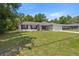Traditional single-story home with black shutters, a two-car garage, and a well-kept lawn at 6306 Pecan Crse, Ocala, FL 34472