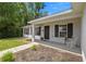 Inviting front porch with a white rocking chair, dark shutters, and a 'Beware of Dog' sign at 6306 Pecan Crse, Ocala, FL 34472