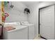 Functional laundry room with washer, dryer, wire shelving, and practical storage solutions at 6306 Pecan Crse, Ocala, FL 34472
